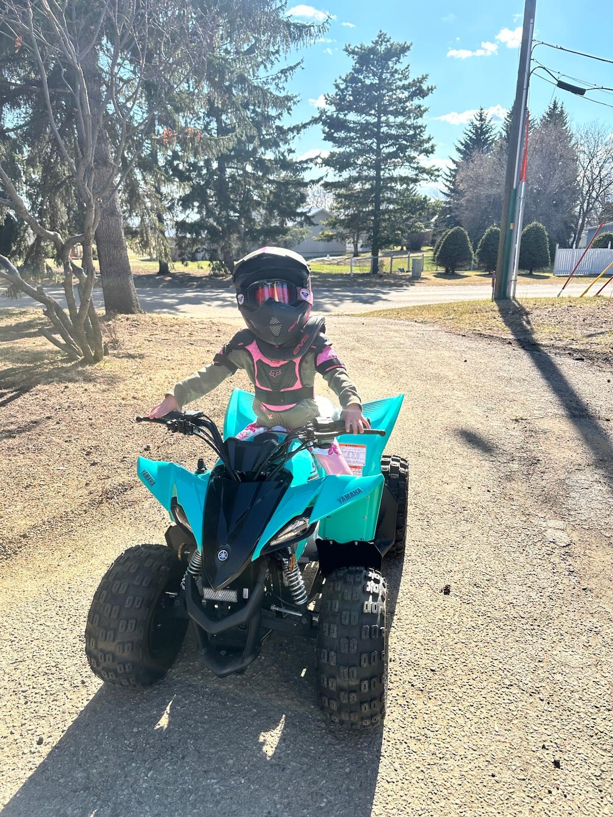 Little Ava with their Yamaha Raptor 90